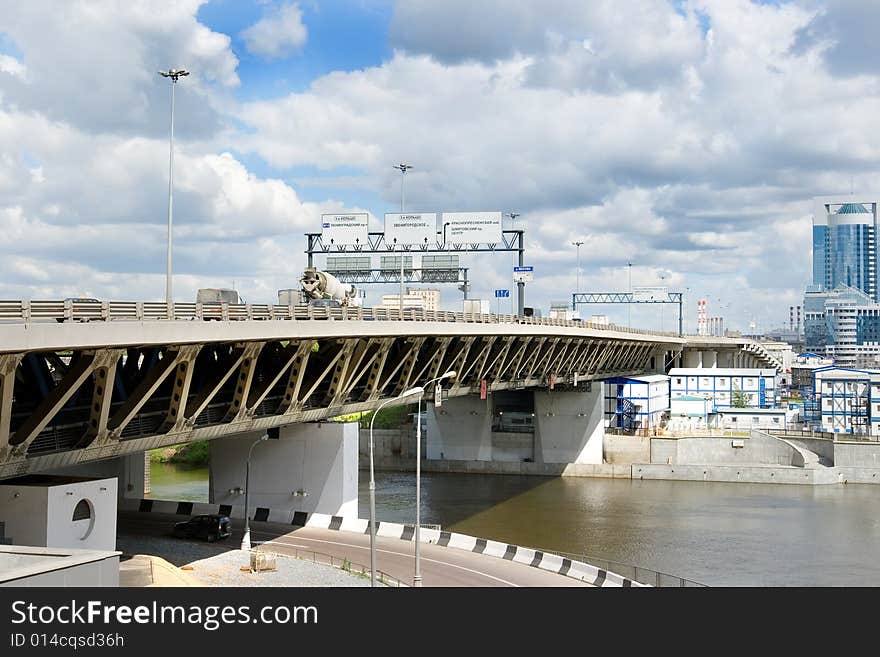 A steel highway bridge busy with automobile traffic. A steel highway bridge busy with automobile traffic