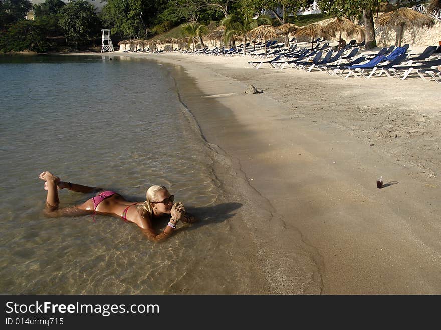 A girl on the beach enjoing the warm water. A girl on the beach enjoing the warm water