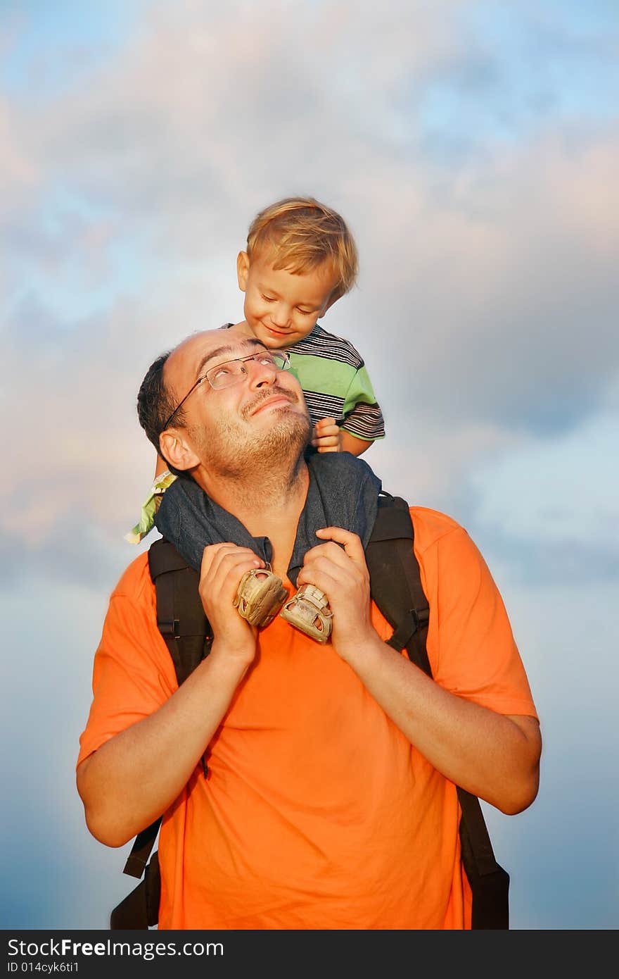 Father and son on sky background