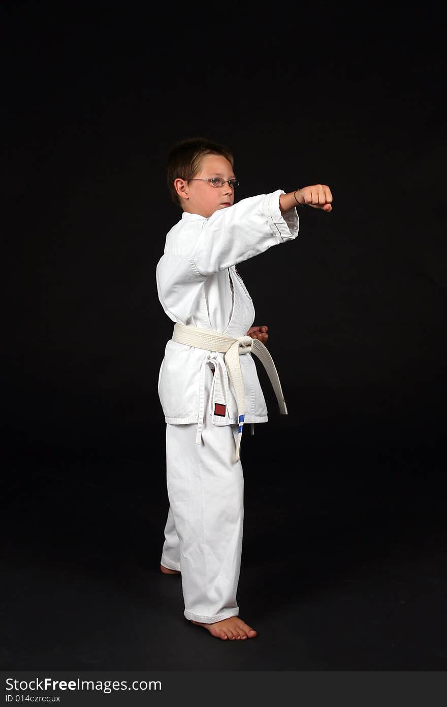 Traditional karate student demonstrating right stance with a punch to the nose. Traditional karate student demonstrating right stance with a punch to the nose
