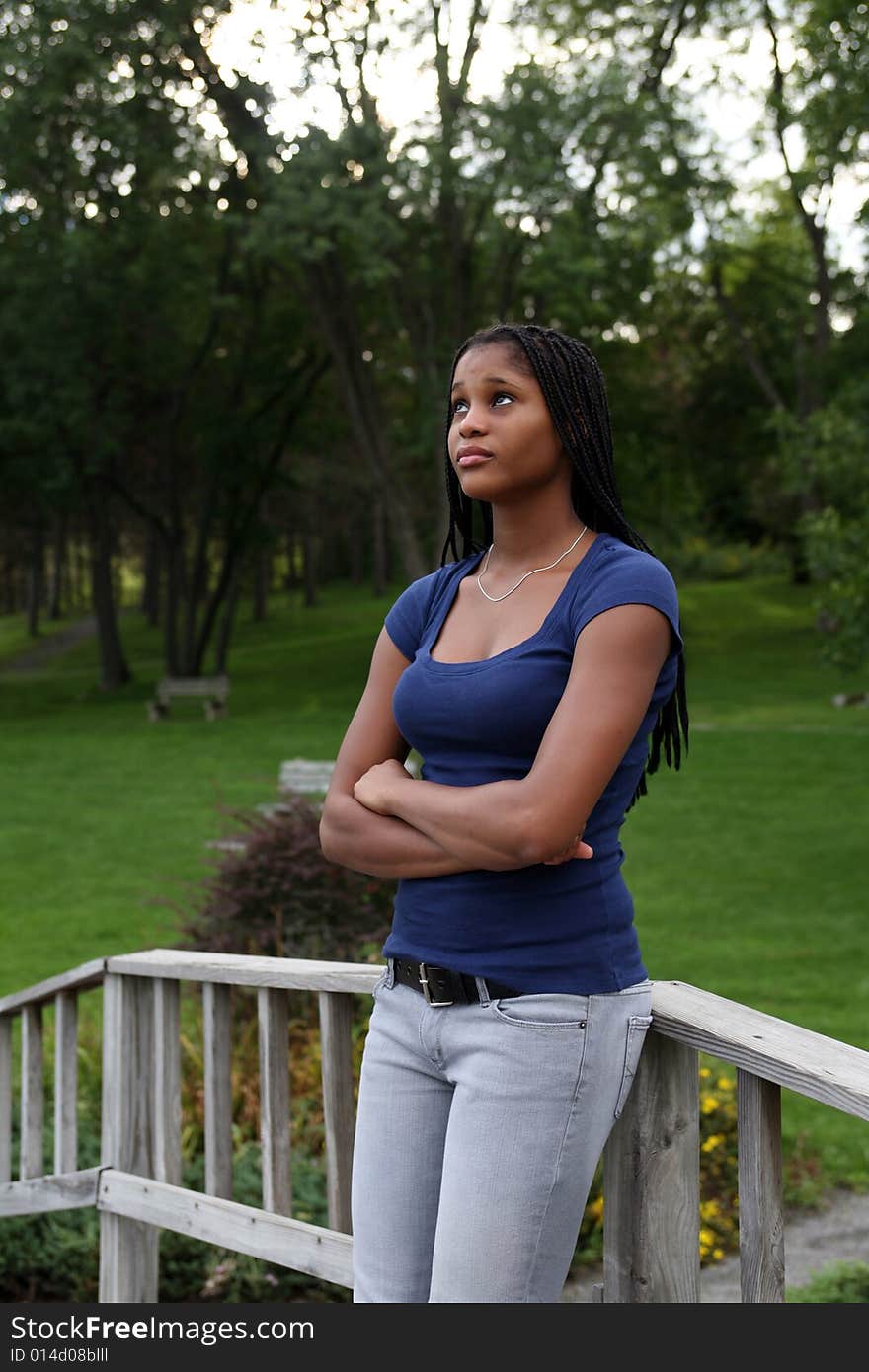 Pretty black teenage girl standing in a park