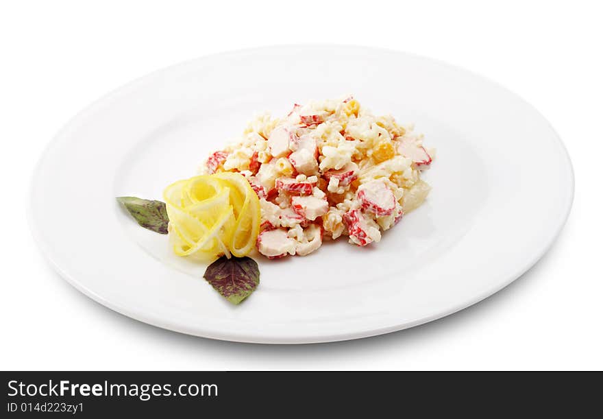 Salad Comprises Crab Meat, Rice, Pineapple and Corn Dressed with Lemon Slice (Abstract Flower) and Leaf of Basil. Isolated on White Background. Salad Comprises Crab Meat, Rice, Pineapple and Corn Dressed with Lemon Slice (Abstract Flower) and Leaf of Basil. Isolated on White Background