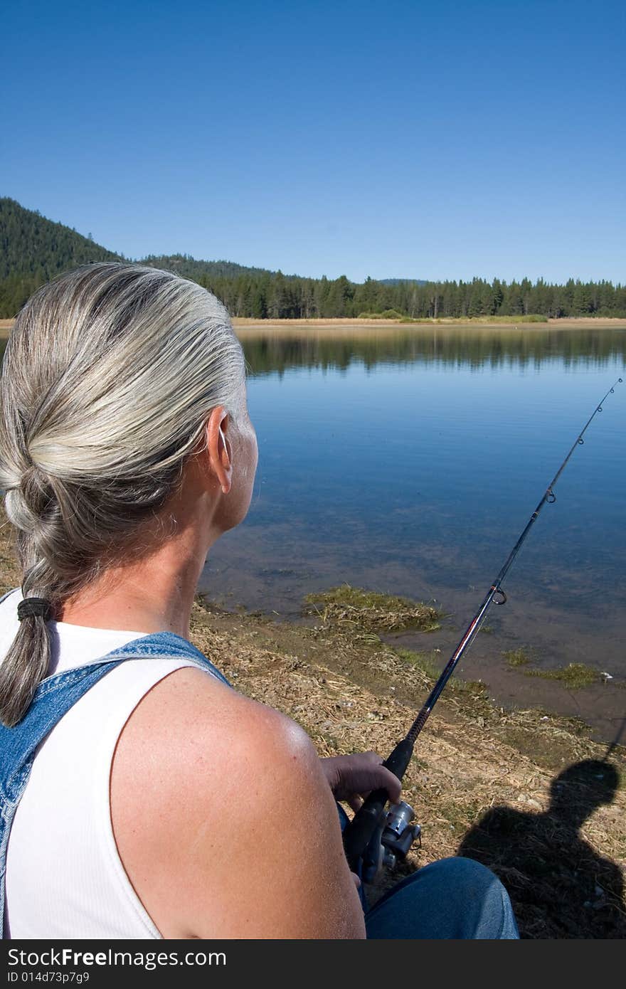 Senior woman fishing at lake