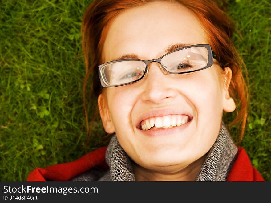 Beautiful young redhead woman relaxing outdoors