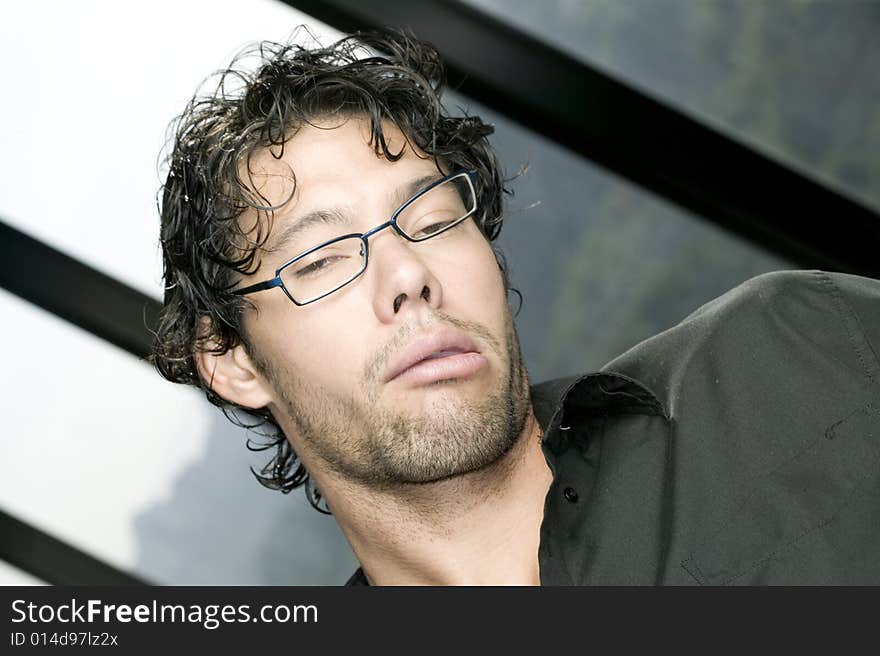 Young man with glasses making a funny face. Young man with glasses making a funny face