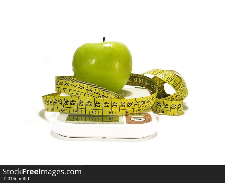 Green apple, scale and tape measure isolated. Green apple, scale and tape measure isolated