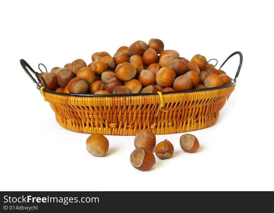 Wood nuts in a basket isolated on a white background. Wood nuts in a basket isolated on a white background