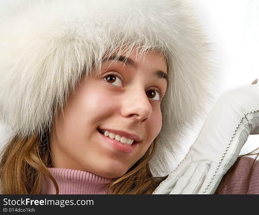 Beauty young girl teenager face portrait in white fur cap and glove with smile. Beauty young girl teenager face portrait in white fur cap and glove with smile.