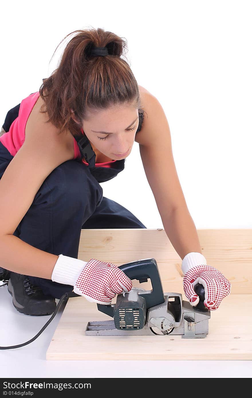 Woman carpenter at work on white background