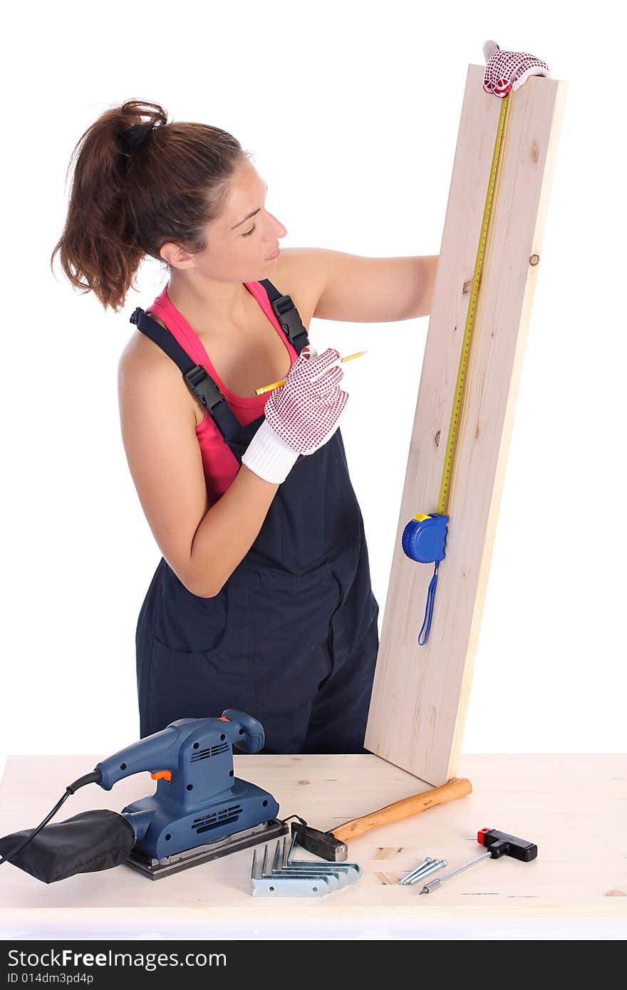 Woman carpenter with wooden plank and measuring tape