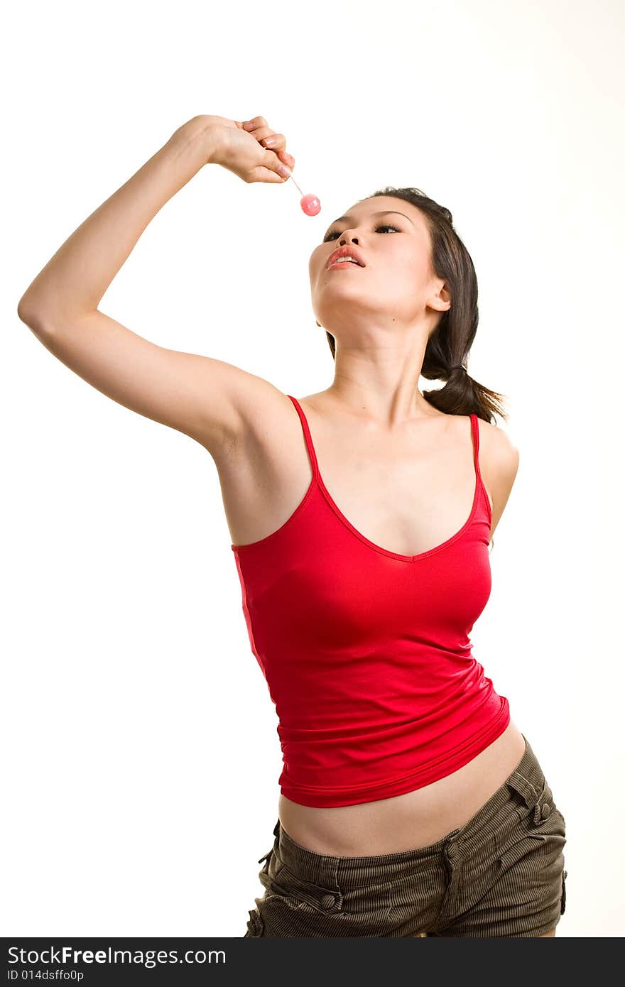 Young asian woman having fun eating lollipop. Young asian woman having fun eating lollipop