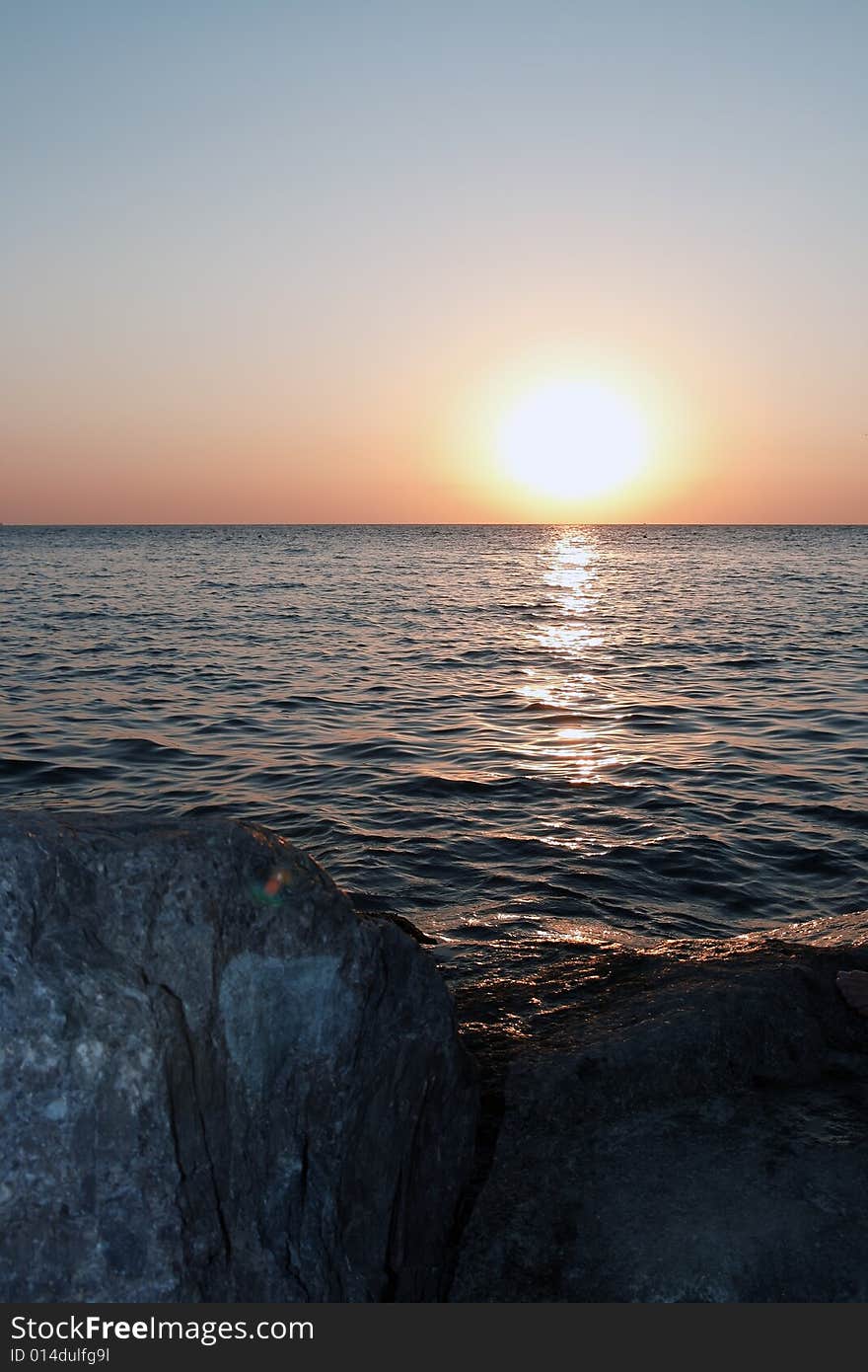 Sea sunset with sun and stones