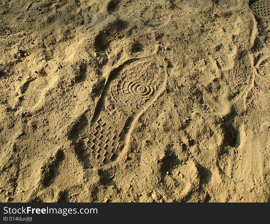 The foot of the unknown person has left a print in a dust. The foot of the unknown person has left a print in a dust