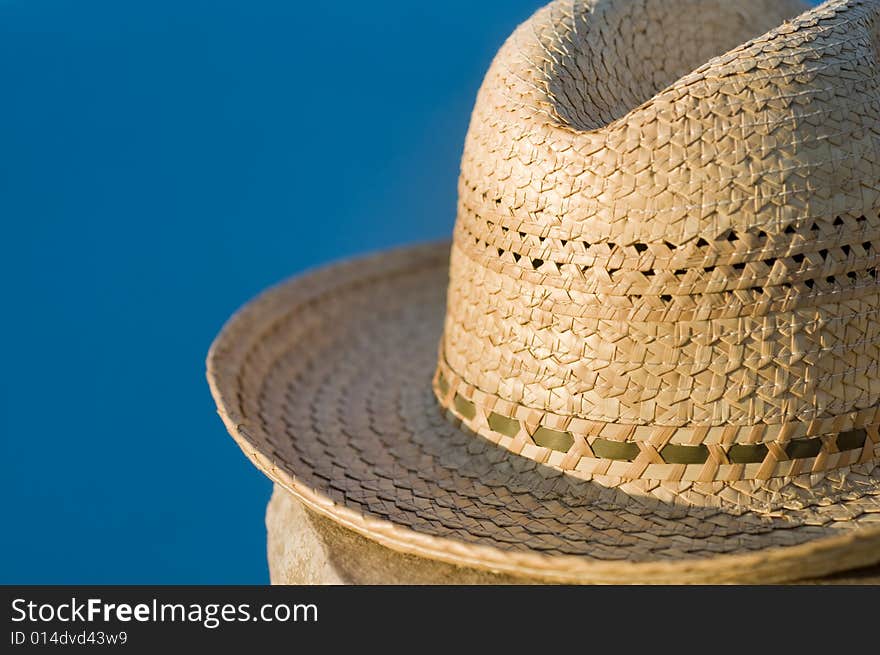 A Straw Hat Sitting Beside Pool