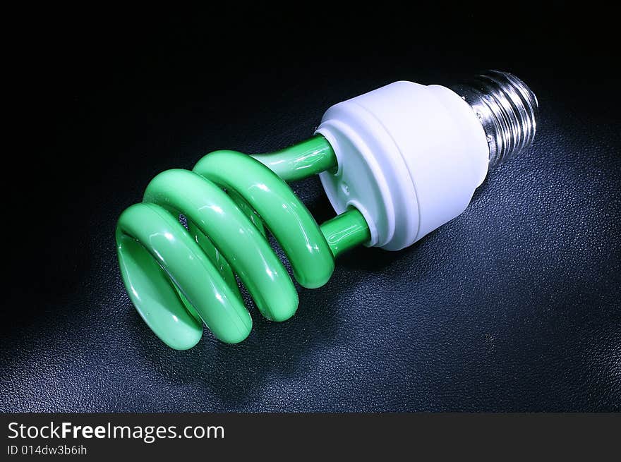 Background with green energy-efficient electric bulb. Background with green energy-efficient electric bulb