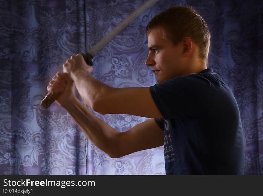 Studio portrait of young man and katana