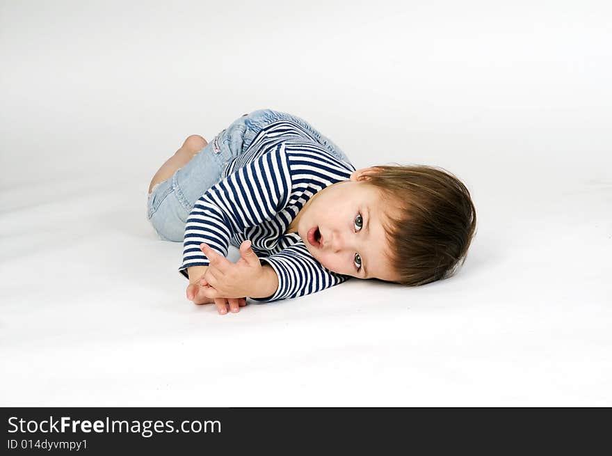 Child  in sailor's striped vest lying down isolated on white