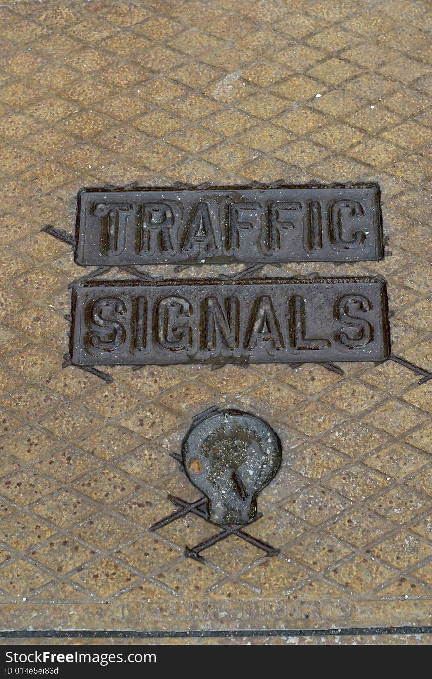 Metal traffic signals sign on pavement. Metal traffic signals sign on pavement