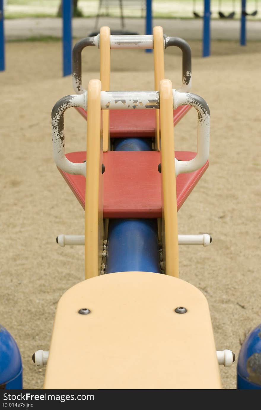 Multi-colored playground toy on a cloudy day.