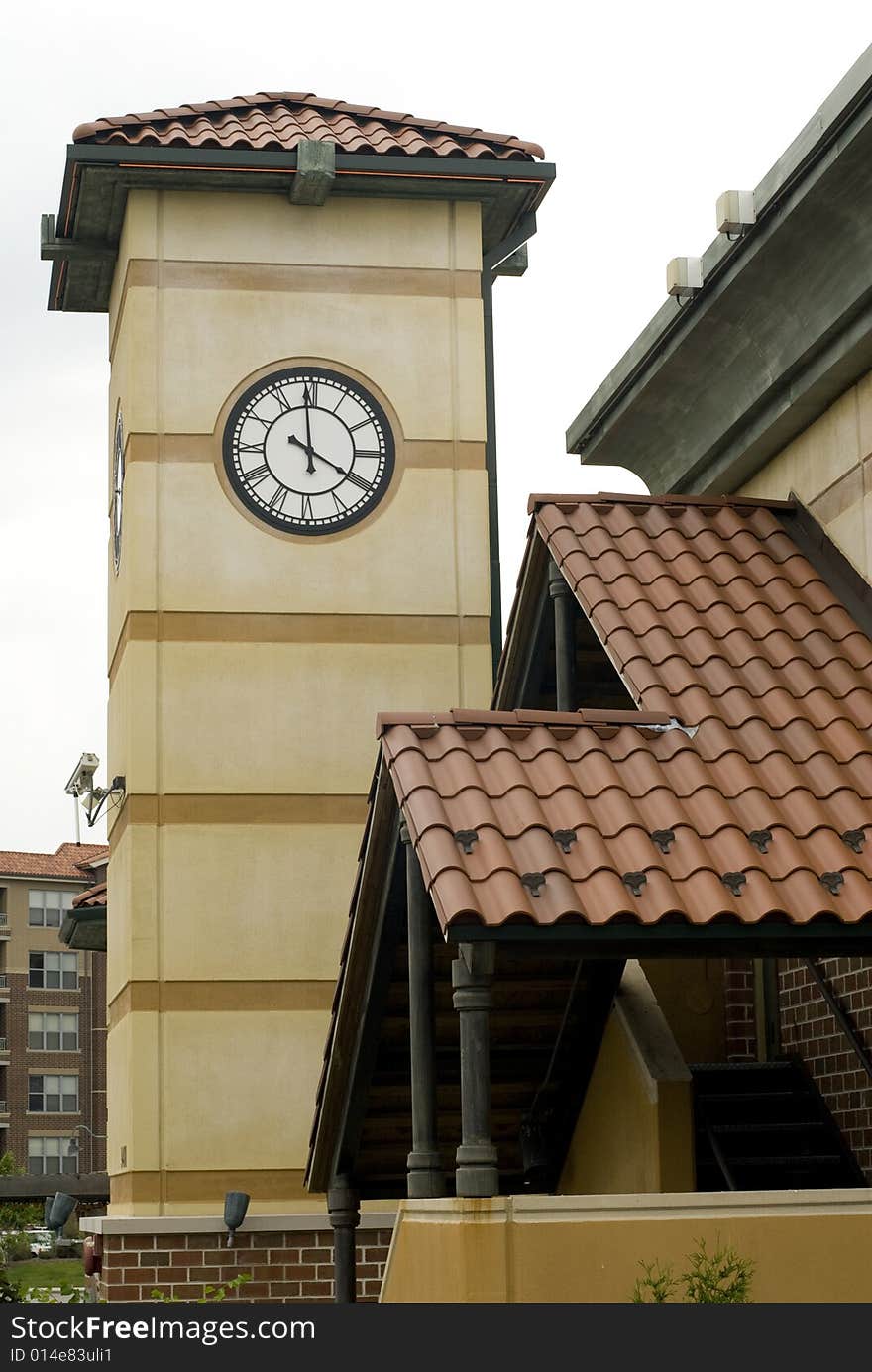 Image of a building with a clock tower and Spanish-style roof. Image of a building with a clock tower and Spanish-style roof