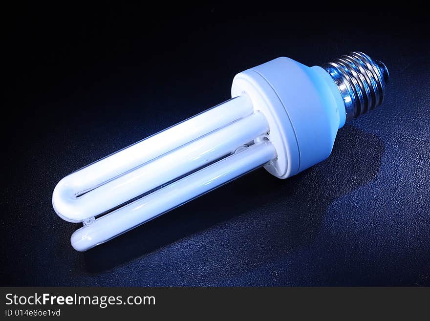 Background with white energy-efficient electric bulb. Background with white energy-efficient electric bulb