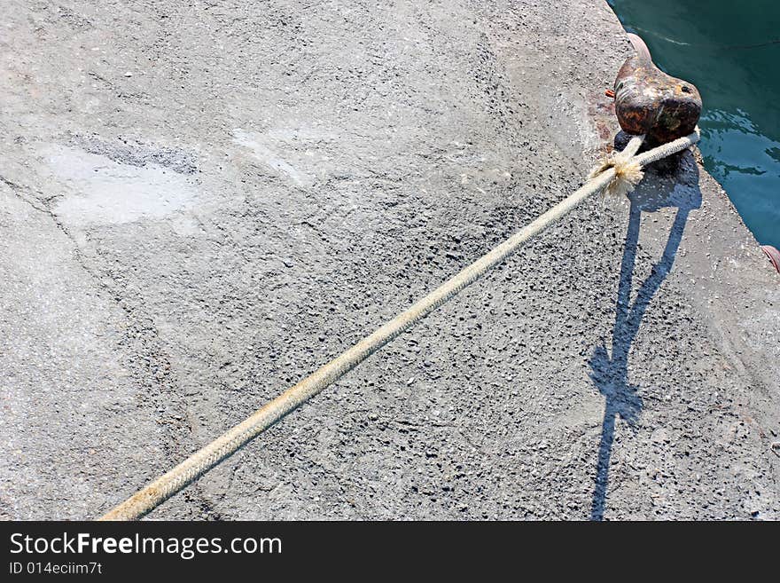 The mooring cable of a ship, fastened in a port. The mooring cable of a ship, fastened in a port