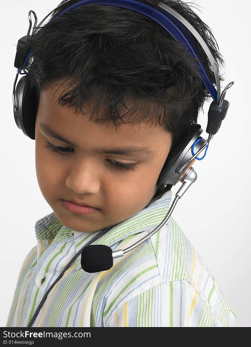 Asian boy with headphones looking down. Asian boy with headphones looking down