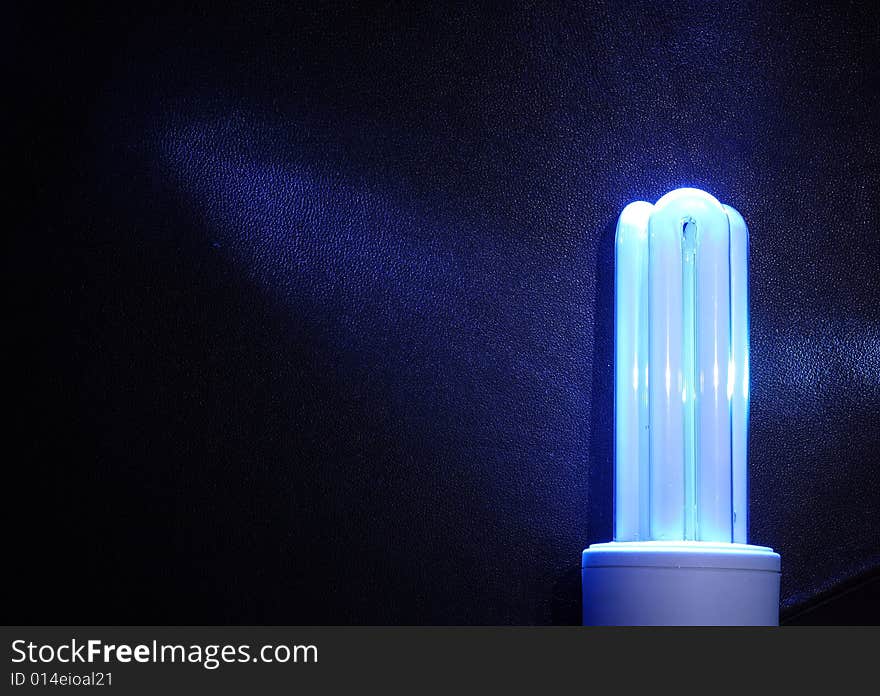 Background with white energy-efficient electric bulb. Background with white energy-efficient electric bulb