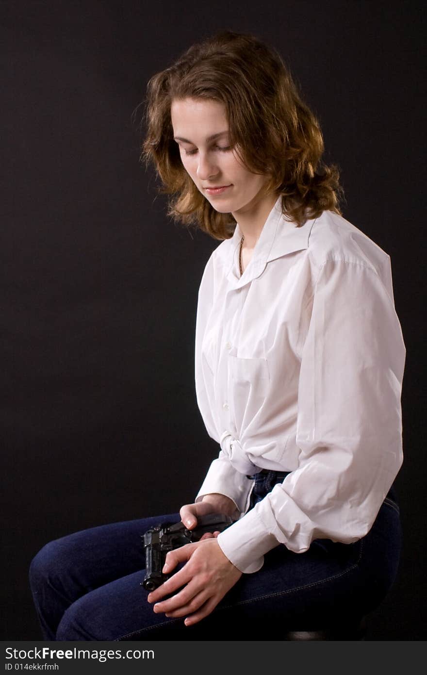 Woman on black handing gun. Woman on black handing gun