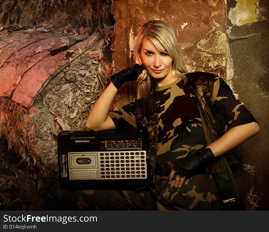 Beautiful female soldier with a retro music player