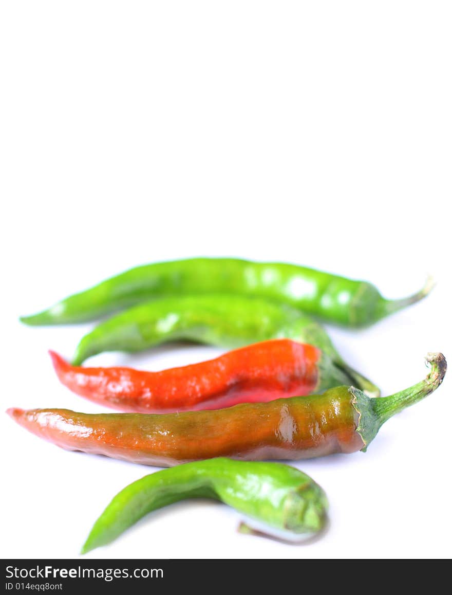 Chili peppers isolated on white background. Shot with shallow depth of field. Chili peppers isolated on white background. Shot with shallow depth of field