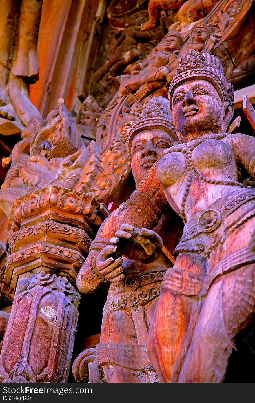 In Thailand in the city of Pattaya the sanctuary of truth is a wooden construction high of 105 meter covered with wooden carved sculpture; view of the sculpted roof. In Thailand in the city of Pattaya the sanctuary of truth is a wooden construction high of 105 meter covered with wooden carved sculpture; view of the sculpted roof