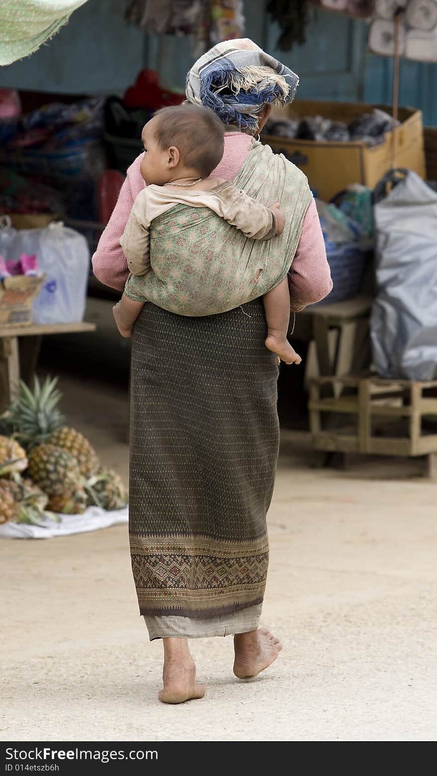 Asia, old woman with grandchild in a village of Laos