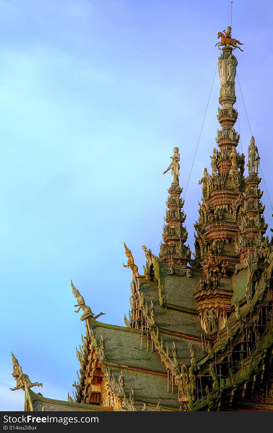 In Thailand in the city of Pattaya the sanctuary of truth is a wooden construction high of 105 meter covered with wooden carved sculpture; view of the sculpted roof. In Thailand in the city of Pattaya the sanctuary of truth is a wooden construction high of 105 meter covered with wooden carved sculpture; view of the sculpted roof