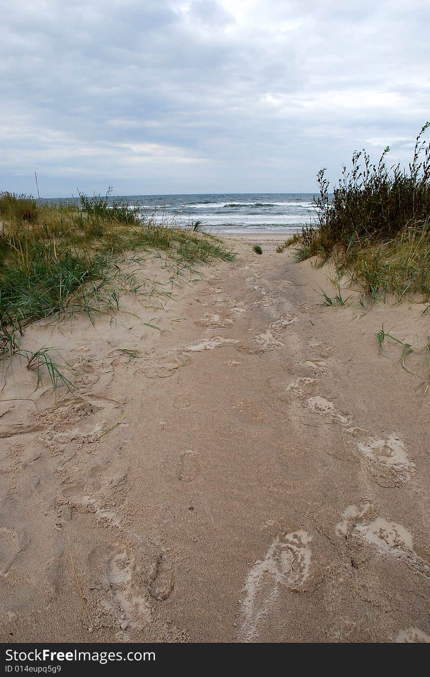 Human footprints on the wet sand on a rainy day. Human footprints on the wet sand on a rainy day.