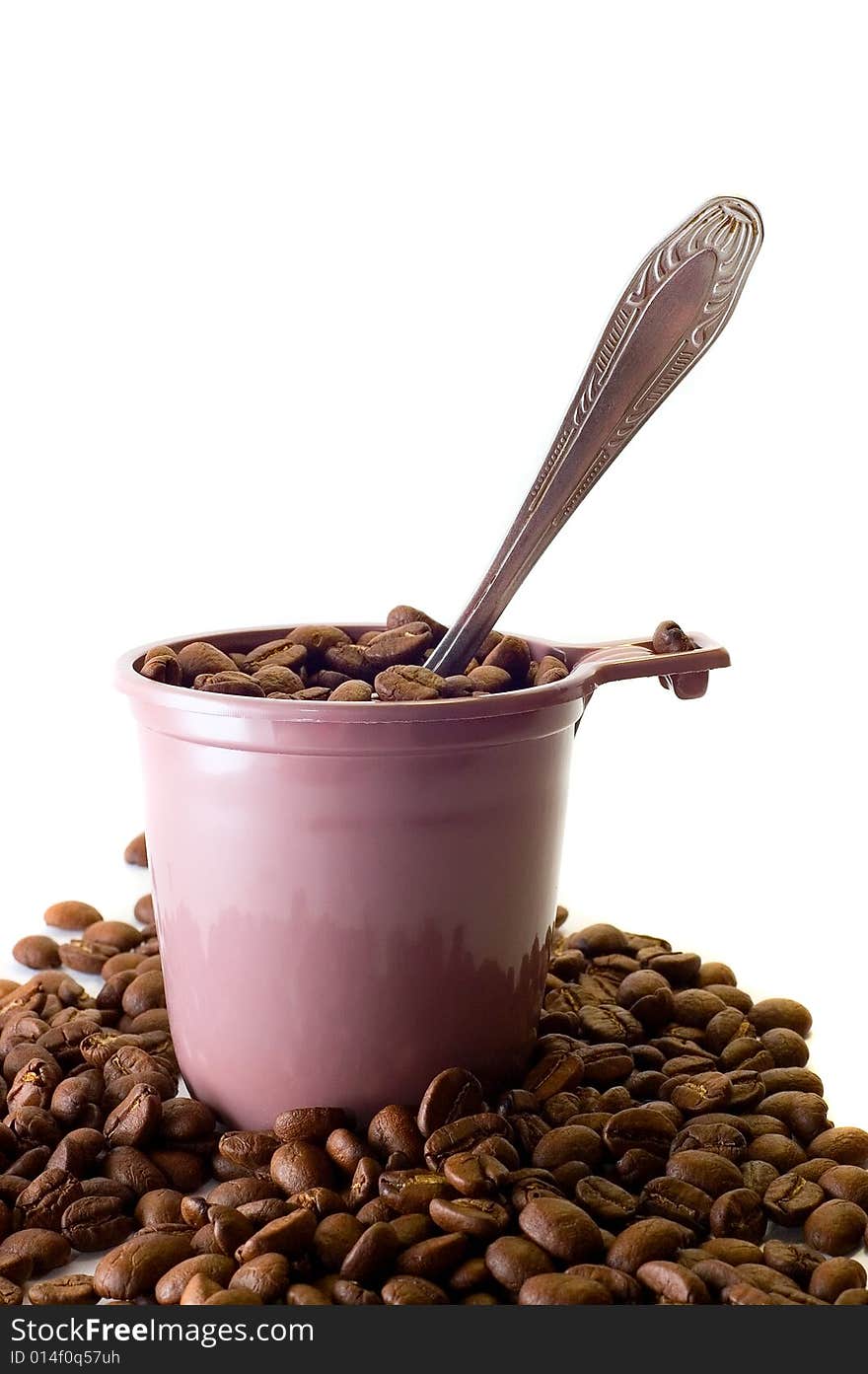 Cup with spoon and coffee beans