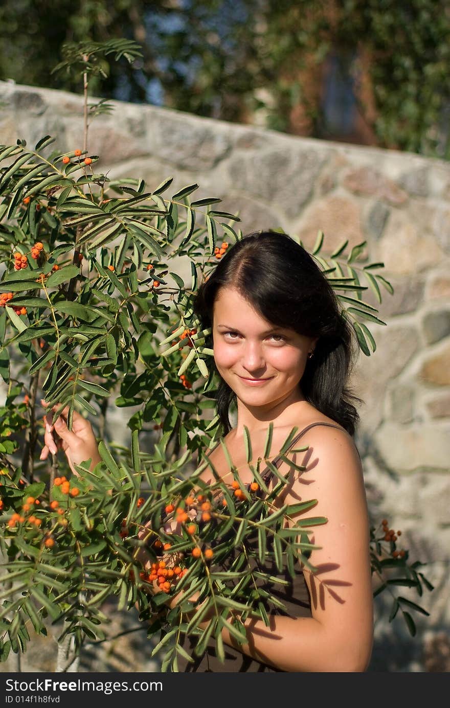 A young woman on holiday in the village. photo against a backdrop of mountain ash. A young woman on holiday in the village. photo against a backdrop of mountain ash.