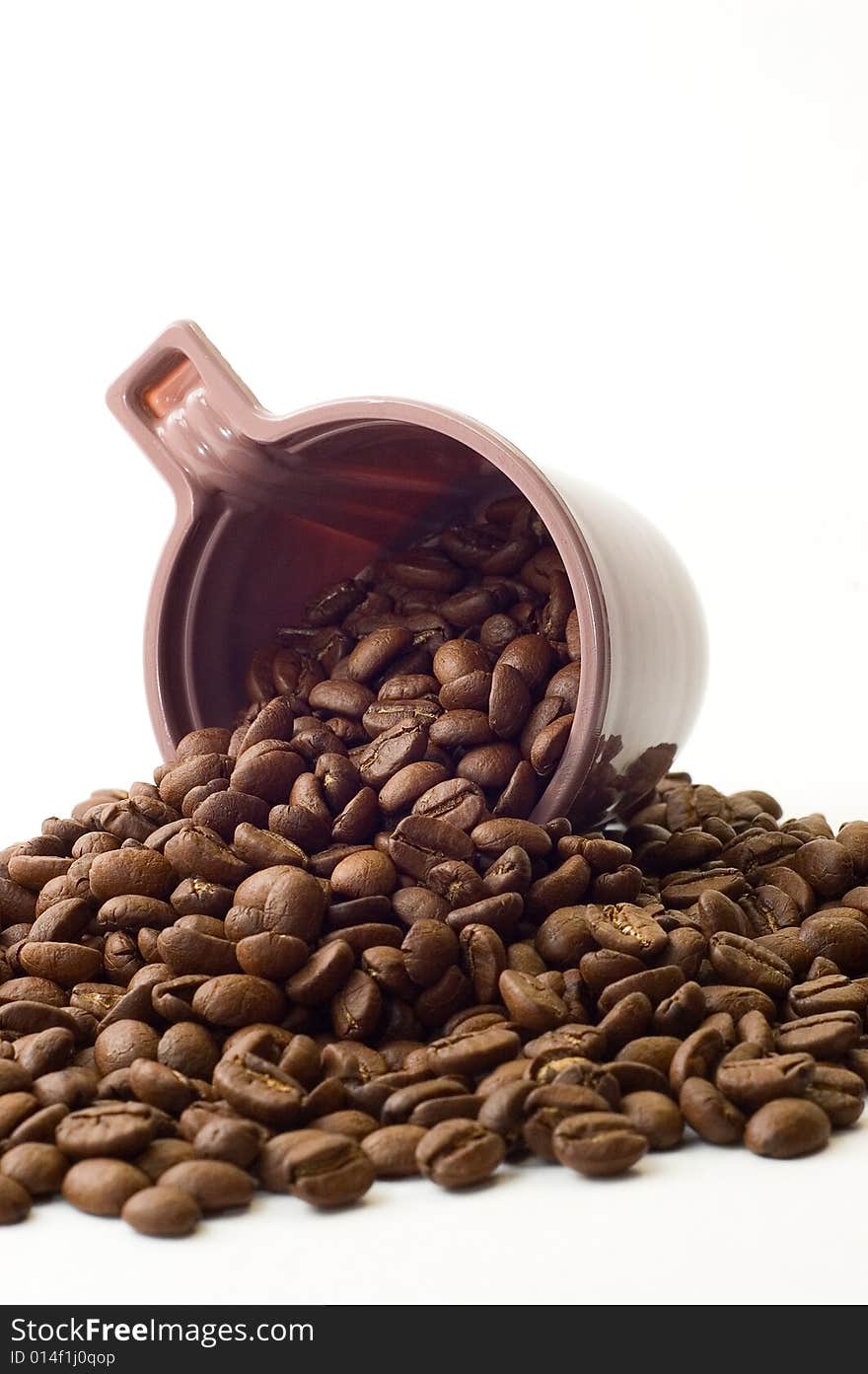 Cup with coffee beans on white