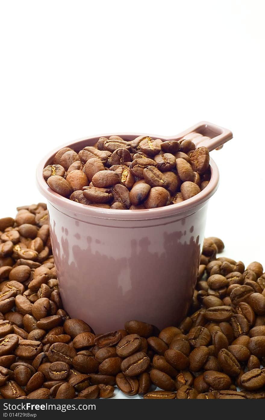 Cup with coffee beans on white