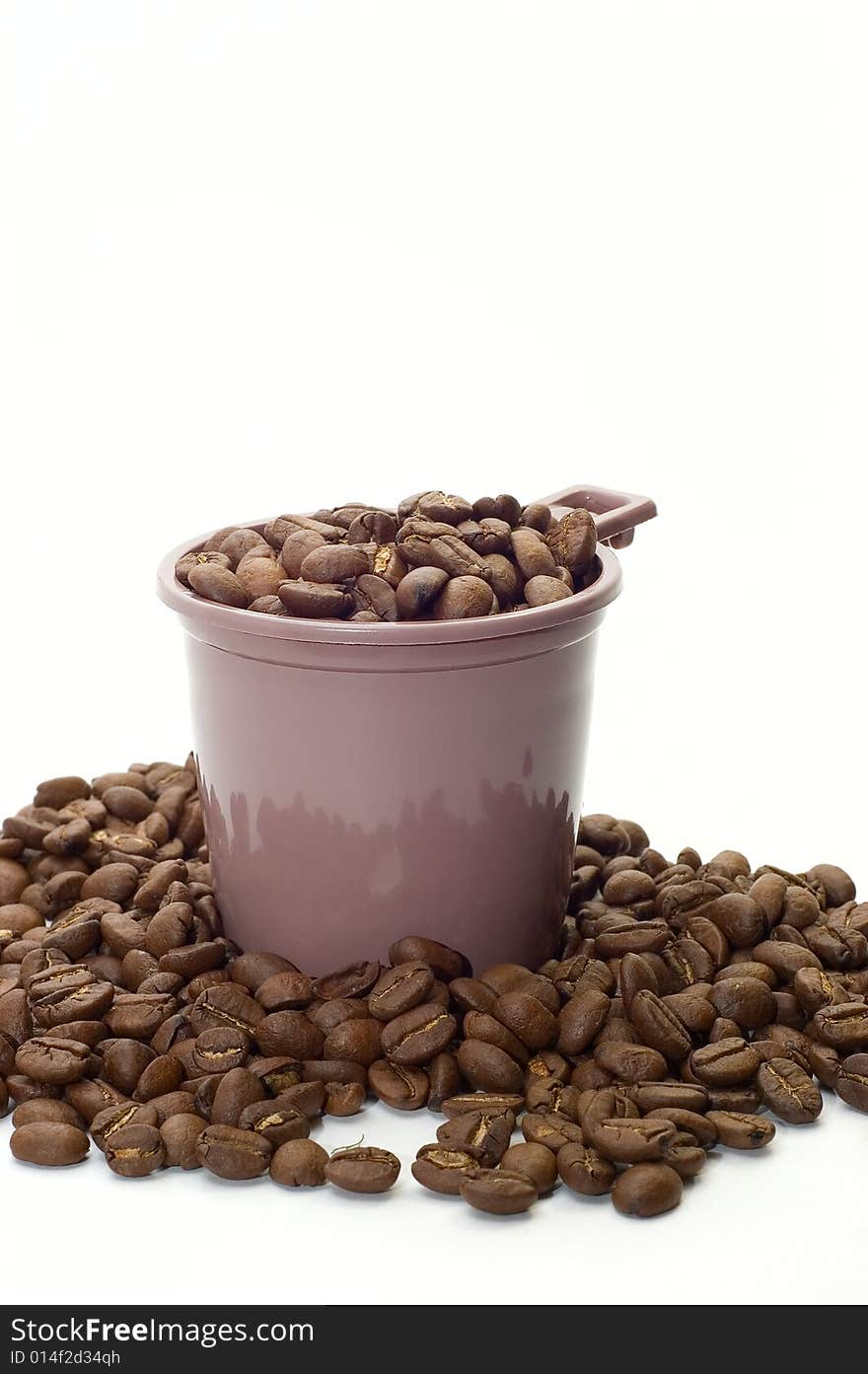 Cup with coffee beans on white