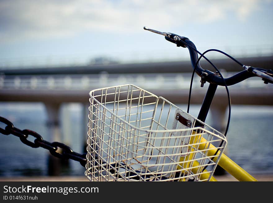 A bike with a basket was posed at seaside. A bike with a basket was posed at seaside