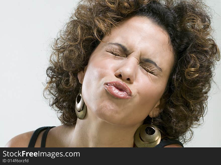 Close up picture of young woman making a funny expression. Close up picture of young woman making a funny expression