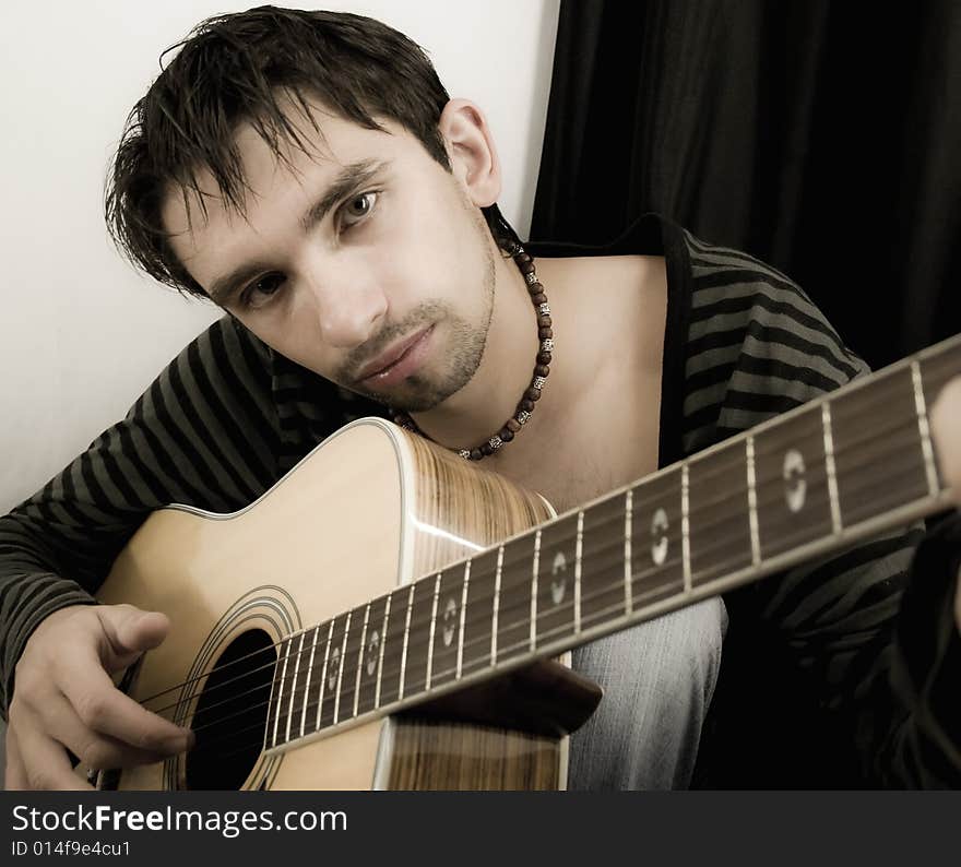 Portrait of the young man with a guitar