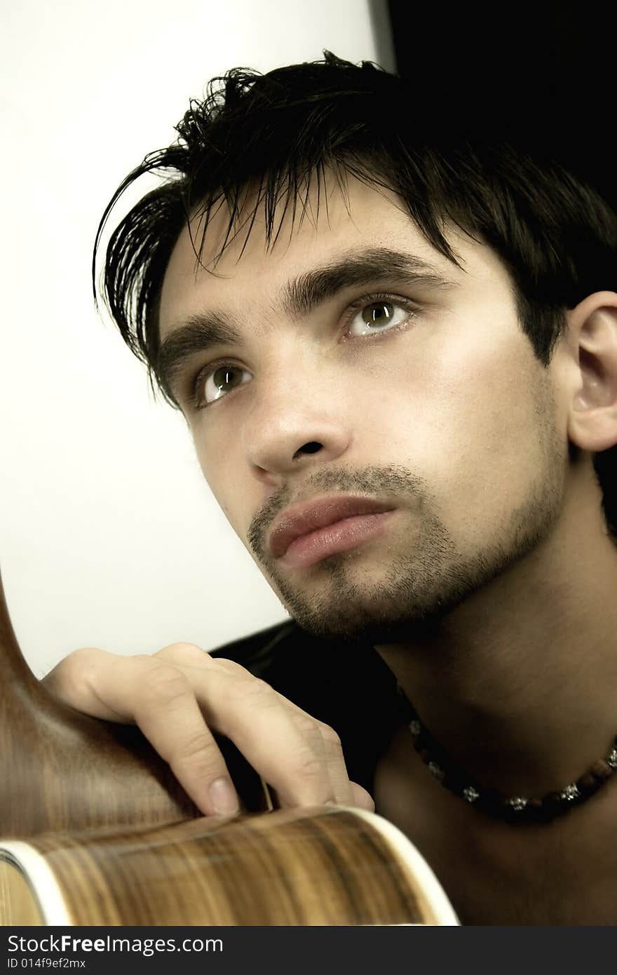 Portrait of the young man with a guitar