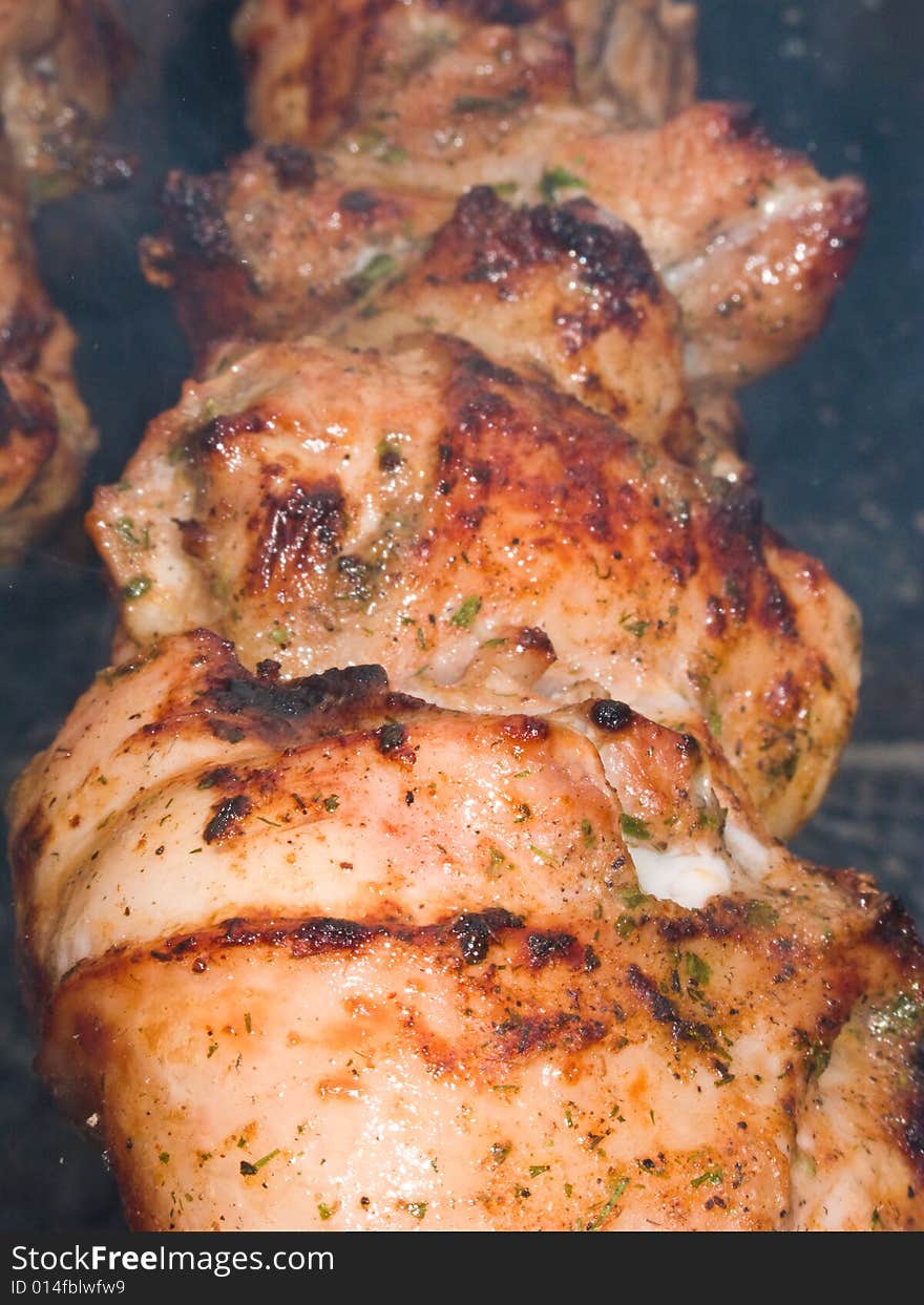 Shish kebab preparation on a brazier. Outdoor picnic. Close up.