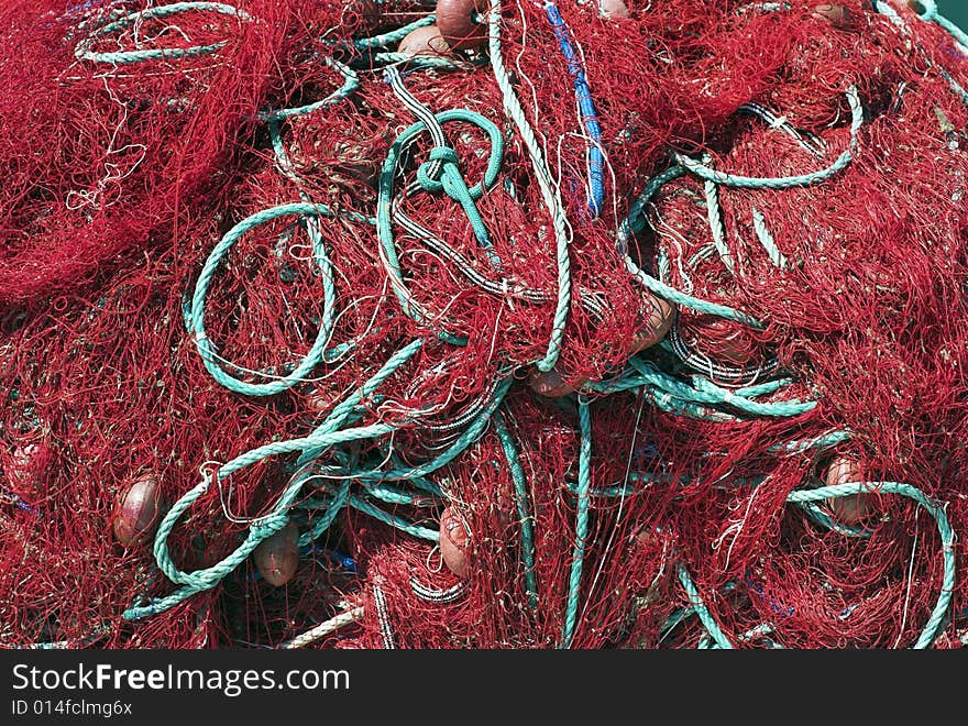 Red Fishing Net and Green Rope. Trawler Net Close-Up