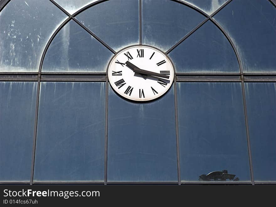 Clock on glass building wall.
Outdoors in the sun. Clock on glass building wall.
Outdoors in the sun.