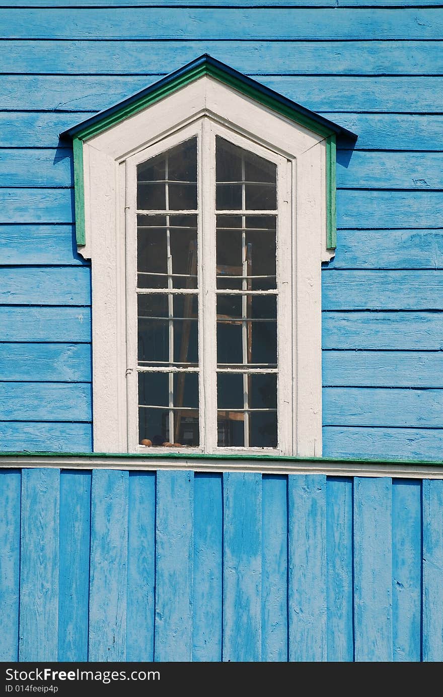 Old window on the blue wall