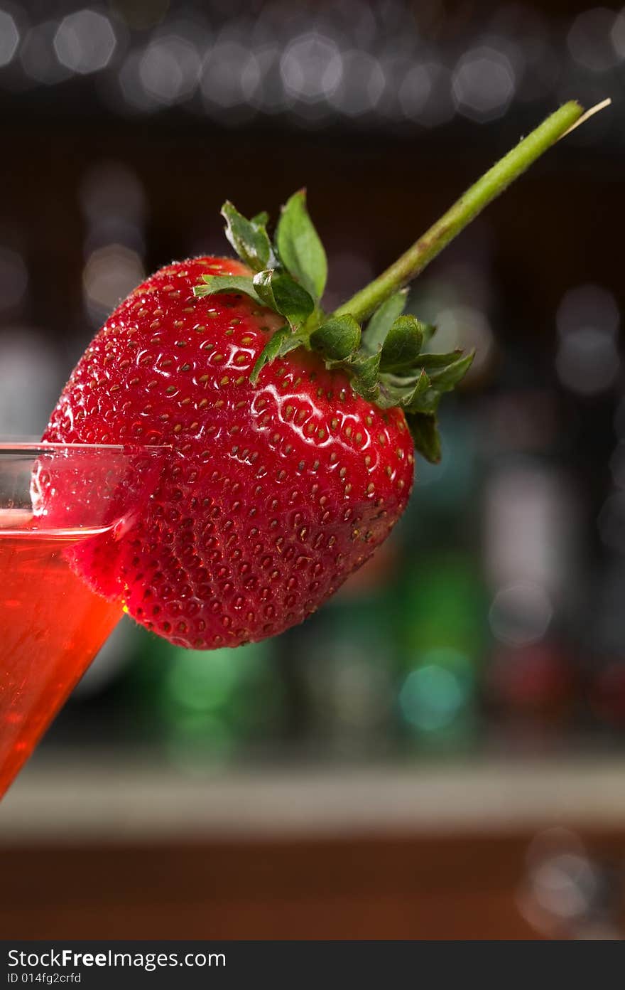 Strawberry on a Martini glass at a bar. Strawberry on a Martini glass at a bar.