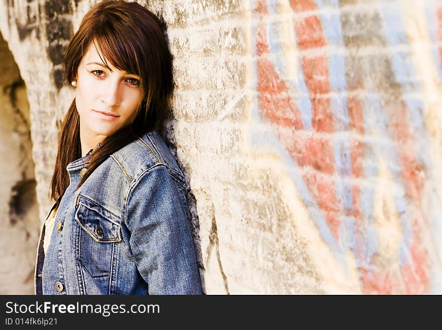 Young woman in casual clothing on brickwall. Young woman in casual clothing on brickwall